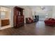 A bright living room features wood floors, an ornate cabinet, and a red couch at 7720 W Agate Ave, Las Vegas, NV 89113