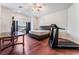 Bright main bedroom with a king size bed, hardwood floors, and ceiling fan at 7720 W Agate Ave, Las Vegas, NV 89113