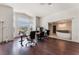 Open office area next to bathroom featuring hardwood floors, and large windows at 7720 W Agate Ave, Las Vegas, NV 89113