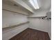 Spacious walk-in closet with wooden floor, multiple racks and shelves for optimal storage solutions at 7720 W Agate Ave, Las Vegas, NV 89113