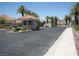 Gated community entrance with a security booth surrounded by palm trees at 7955 Canto Ave, Las Vegas, NV 89147