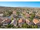 Wide aerial shot of a residential area showing the layout of homes, streets, and green spaces in the neighborhood at 8083 Shadowvale Dr, Las Vegas, NV 89147