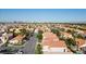Panoramic aerial of a residential community, highlighting the expansive landscape and the city skyline in the distance at 8083 Shadowvale Dr, Las Vegas, NV 89147