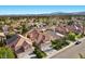 Neighborhood aerial showcasing well-maintained homes with lush landscaping and mature trees in a desirable community at 8083 Shadowvale Dr, Las Vegas, NV 89147