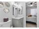 Contemporary bathroom with a sink vanity, decorative mirrors, and adjacent bedroom view at 8083 Shadowvale Dr, Las Vegas, NV 89147