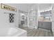 Well-lit bathroom features a large vanity, separate glass-enclosed shower, and a soaking tub at 8083 Shadowvale Dr, Las Vegas, NV 89147