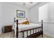 Cozy bedroom with a queen-size bed, neutral walls, wood-style flooring, and a decorative throw at 8083 Shadowvale Dr, Las Vegas, NV 89147