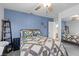 Bright bedroom featuring a blue accent wall, carpeted floors, and contemporary decor at 8083 Shadowvale Dr, Las Vegas, NV 89147