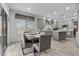 Bright dining area adjacent to the kitchen, featuring large windows and backyard access at 8083 Shadowvale Dr, Las Vegas, NV 89147