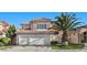 Charming two-story home boasts a three car garage, red tile roof, and lush landscaping at 8083 Shadowvale Dr, Las Vegas, NV 89147