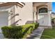 Elegant front entrance features double doors, pillars, manicured bushes, and a tile roof at 8083 Shadowvale Dr, Las Vegas, NV 89147