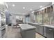 Modern kitchen features stainless steel appliances, light countertops, and eat-in breakfast area at 8083 Shadowvale Dr, Las Vegas, NV 89147