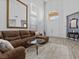 Bright living room with high ceilings, transom windows, and plush sectional seating at 8083 Shadowvale Dr, Las Vegas, NV 89147