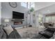 Modern living room with a fireplace, large TV, neutral decor, and an open floor plan at 8083 Shadowvale Dr, Las Vegas, NV 89147