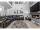 Inviting living room featuring a fireplace, large TV, and comfortable seating, perfect for relaxation at 8083 Shadowvale Dr, Las Vegas, NV 89147