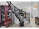Elegant staircase with black railings and carpeted steps, leading to the upper level at 8083 Shadowvale Dr, Las Vegas, NV 89147