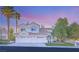 Stunning two-story home with a three-car garage and lush landscaping at 8100 Lake Hills Dr, Las Vegas, NV 89128