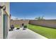 The backyard features artificial grass, a block fence, and an outdoor seating area at 8254 Palladium St, Las Vegas, NV 89113