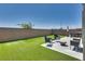 Well-manicured backyard featuring artificial turf, patio, and outdoor seating, perfect for entertaining at 8254 Palladium St, Las Vegas, NV 89113