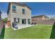A spacious backyard with artificial turf, a patio area, and block wall for privacy at 8254 Palladium St, Las Vegas, NV 89113