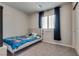 Bedroom with carpet and a blue comforter with a window and white shutters at 8254 Palladium St, Las Vegas, NV 89113