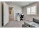 This carpeted bedroom features a desk, office chair, and a window providing natural light at 8254 Palladium St, Las Vegas, NV 89113