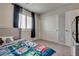 Bedroom featuring carpet and a blue comforter with a window and closet at 8254 Palladium St, Las Vegas, NV 89113
