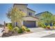 Two-story home showcasing a well-kept front yard, desert landscaping, and a two-car garage at 8254 Palladium St, Las Vegas, NV 89113