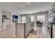 Modern kitchen with gray cabinets, stainless steel appliances, and island with seating at 8254 Palladium St, Las Vegas, NV 89113