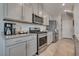 Bright, modern kitchen with stainless steel appliances, gray cabinets, and granite countertops at 8254 Palladium St, Las Vegas, NV 89113
