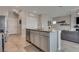 Open kitchen with gray cabinets, stainless steel appliances, and granite countertops at 8254 Palladium St, Las Vegas, NV 89113