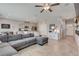 Open-concept living area with tile floors, a large gray sofa, and views of the kitchen and dining area at 8254 Palladium St, Las Vegas, NV 89113