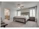 Spacious primary bedroom with neutral tones, ceiling fan, and ensuite bathroom access at 8254 Palladium St, Las Vegas, NV 89113