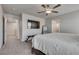 Spacious primary bedroom with large bed, tv, and ensuite bathroom access at 8254 Palladium St, Las Vegas, NV 89113