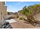 Backyard with desert landscaping, concrete patio, and fenced perimeter at 8448 Quarentina Ave, Las Vegas, NV 89149