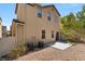 Backyard featuring patio, desert landscaping, and view of stucco house exterior at 8448 Quarentina Ave, Las Vegas, NV 89149