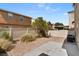 Backyard with gravel landscaping, concrete patio, and fenced perimeter at 8448 Quarentina Ave, Las Vegas, NV 89149
