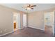 Bedroom featuring a ceiling fan, carpet, and doorways leading to the bathroom and hallway at 8448 Quarentina Ave, Las Vegas, NV 89149