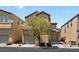 Attractive two-story home with tan stucco, a one-car garage, and a well-maintained front yard with mature tree at 8448 Quarentina Ave, Las Vegas, NV 89149