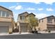 A quaint two-story home with a tan exterior, featuring a single-car garage and mature landscaping at 8448 Quarentina Ave, Las Vegas, NV 89149
