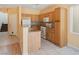 Charming kitchen features oak cabinetry, granite countertops, and white appliances, creating a warm and inviting space at 8448 Quarentina Ave, Las Vegas, NV 89149