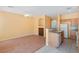 Open-concept space with a view of the kitchen, wood floors, and sunny, yellow walls at 8448 Quarentina Ave, Las Vegas, NV 89149