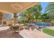 Inviting backyard patio with built-in grill, fire pit and seating area, perfect for outdoor entertaining at 8825 Rozetta Ct, Las Vegas, NV 89134