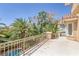 Balcony with views of the mature tropical landscaping and sparkling pool at 8825 Rozetta Ct, Las Vegas, NV 89134
