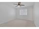 Minimalist bedroom with neutral carpet, plantation shutters, and a ceiling fan; promoting calm and relaxation at 8825 Rozetta Ct, Las Vegas, NV 89134