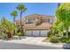 Elegant home with tile roof, three-car garage, balcony, and manicured front yard landscaping at 8825 Rozetta Ct, Las Vegas, NV 89134