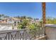 Community view showcasing well-maintained homes, lush landscaping, and mature palm trees on a sunny day at 8825 Rozetta Ct, Las Vegas, NV 89134