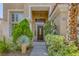 Inviting front entrance with a covered porch, decorative plants, and clear address signage at 8825 Rozetta Ct, Las Vegas, NV 89134