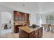 Well-equipped kitchen with a center island, granite countertops, stainless steel appliances, and tile flooring at 8825 Rozetta Ct, Las Vegas, NV 89134