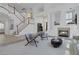 Bright living room with fireplace, staircase, high ceilings, and modern furnishings at 8825 Rozetta Ct, Las Vegas, NV 89134